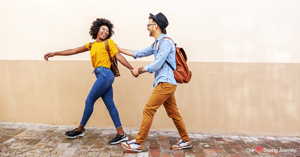 Interracial couple outside walking and flirting